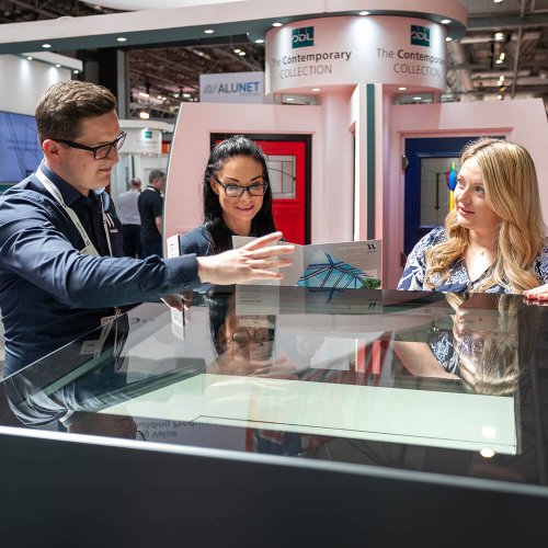 Three people in discussion at FIT Show
